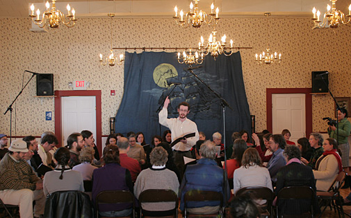 Wide shot of Jesse leading the Azariah singing